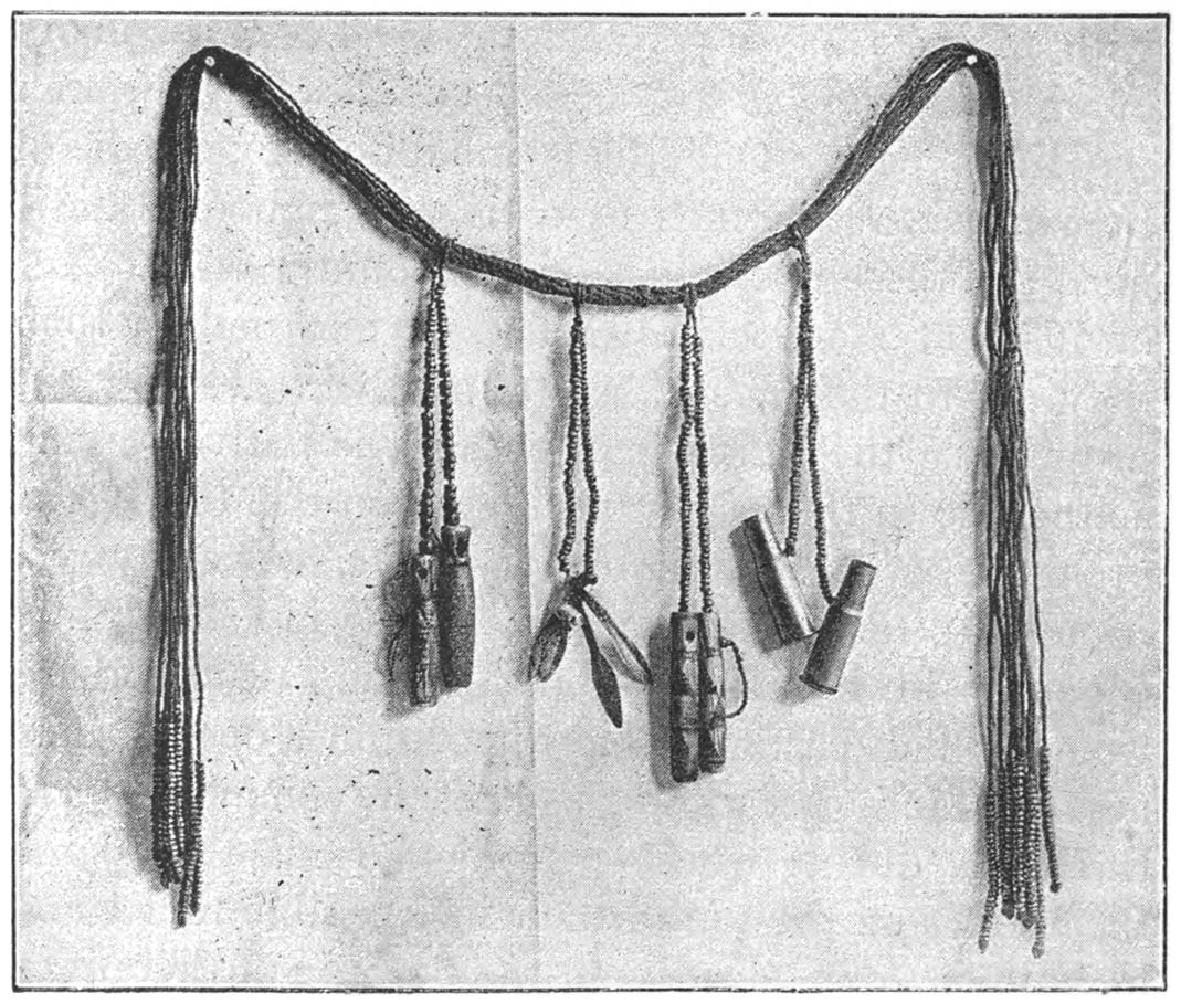 WOMAN’S GIRDLE, WITH CARTRIDGE CASES, SKIN-SCRAPERS, AND MEDICINE PHIALS ATTACHED