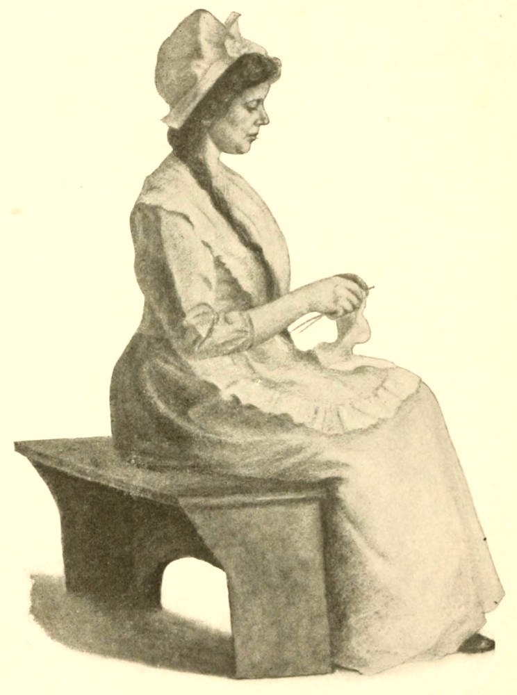 A woman sitting on a bench and knitting