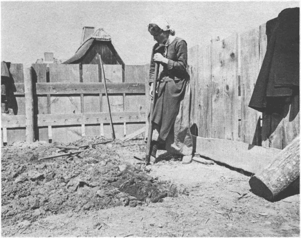 Woman turning over dirt