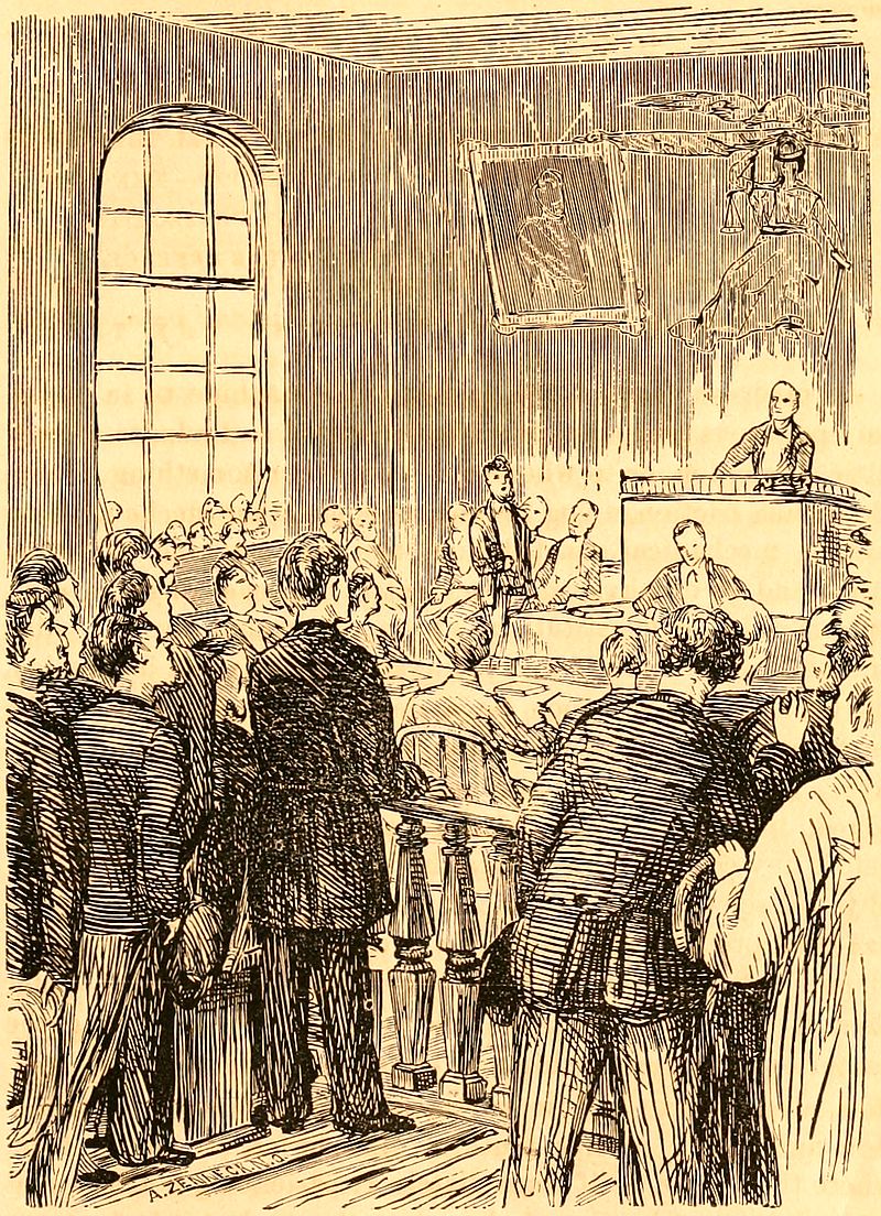 A judge presides over a courtroom full of people.