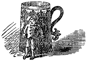 Piskey standing in front of mug.