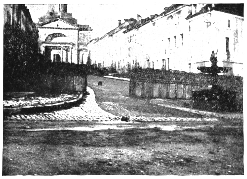 Street with multiple buildings showing defensive structures.