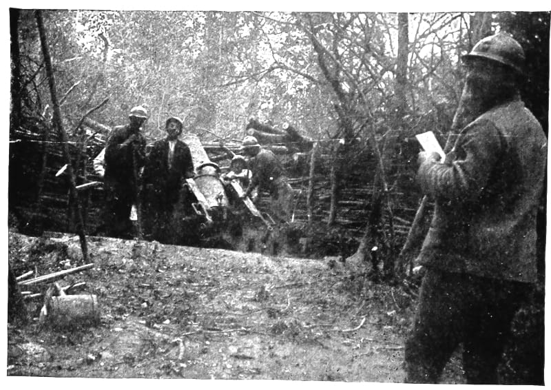 Men stand behind a wooden wall operating machinery.