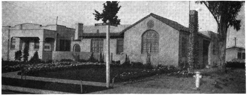 Picture of a house with a tree in front of it