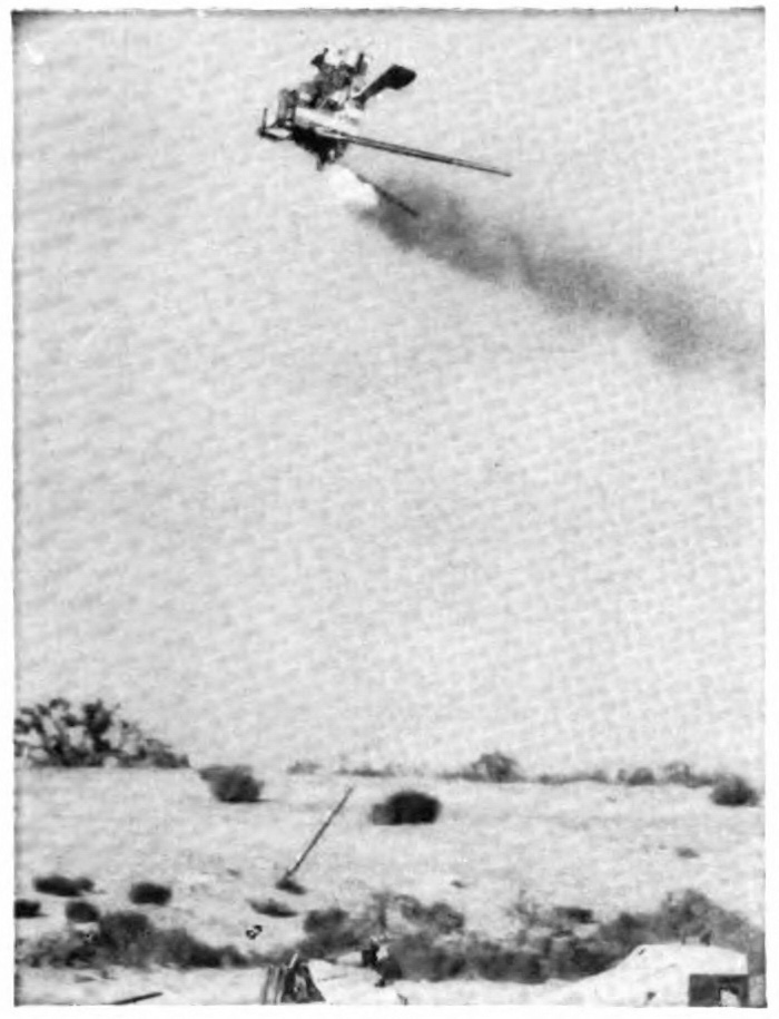 A plane with a plume of smoke behind it and a white object emerging