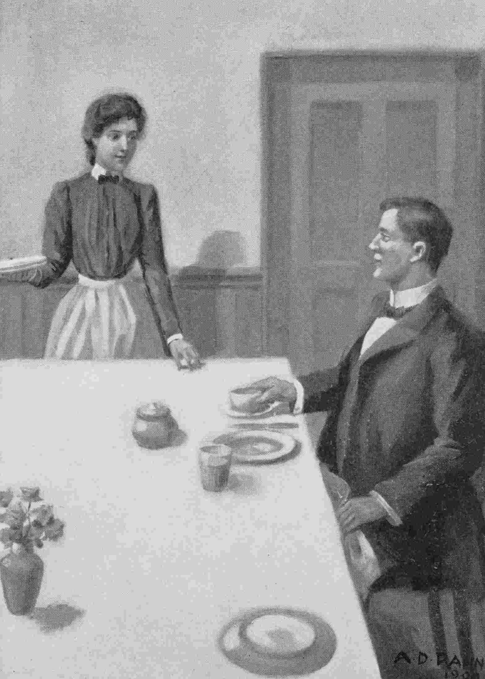 Woman standing speaks to man sitting at table