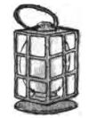 This black-and-white drawing shows a traditional lantern. The lantern has a rectangular box-shaped body and a flat circular base. A metal cage with a grid pattern protects the light source, and clear glass panels fit inside the frame. Inside the cage is a rounded bulb or candle shape. At the top, there is a simple wire or leather loop handle for carrying.