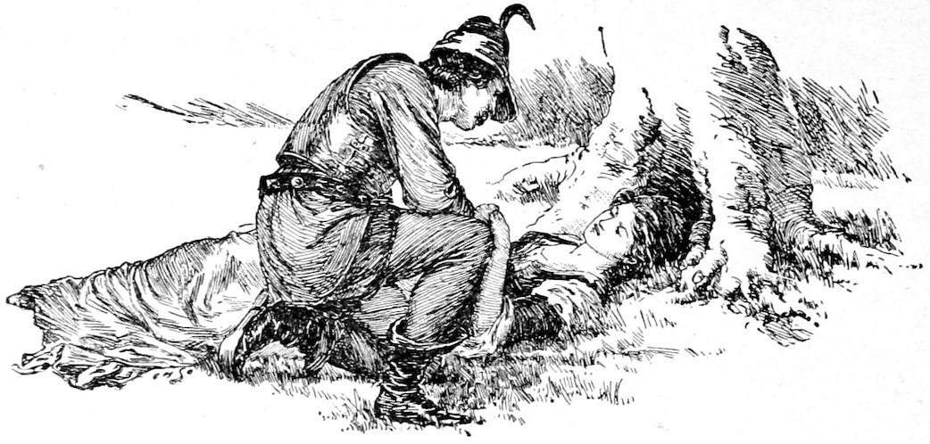 A man kneeling beside a woman lying on the ground.