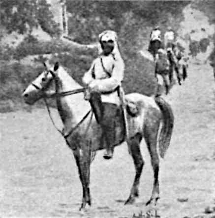 Man riding horse, with people in background