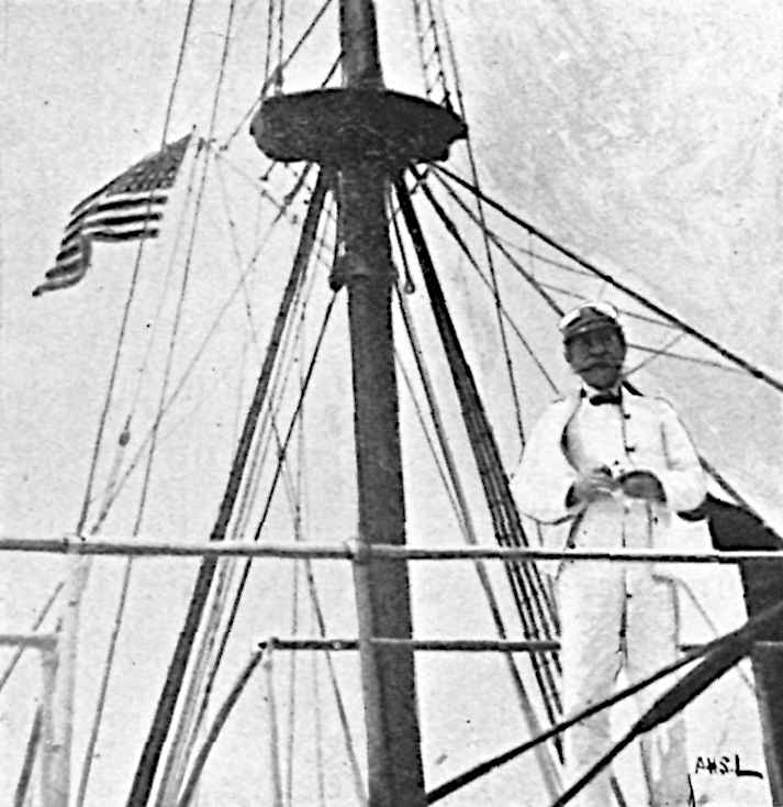 Man on right with mast in middle and American flag on left
