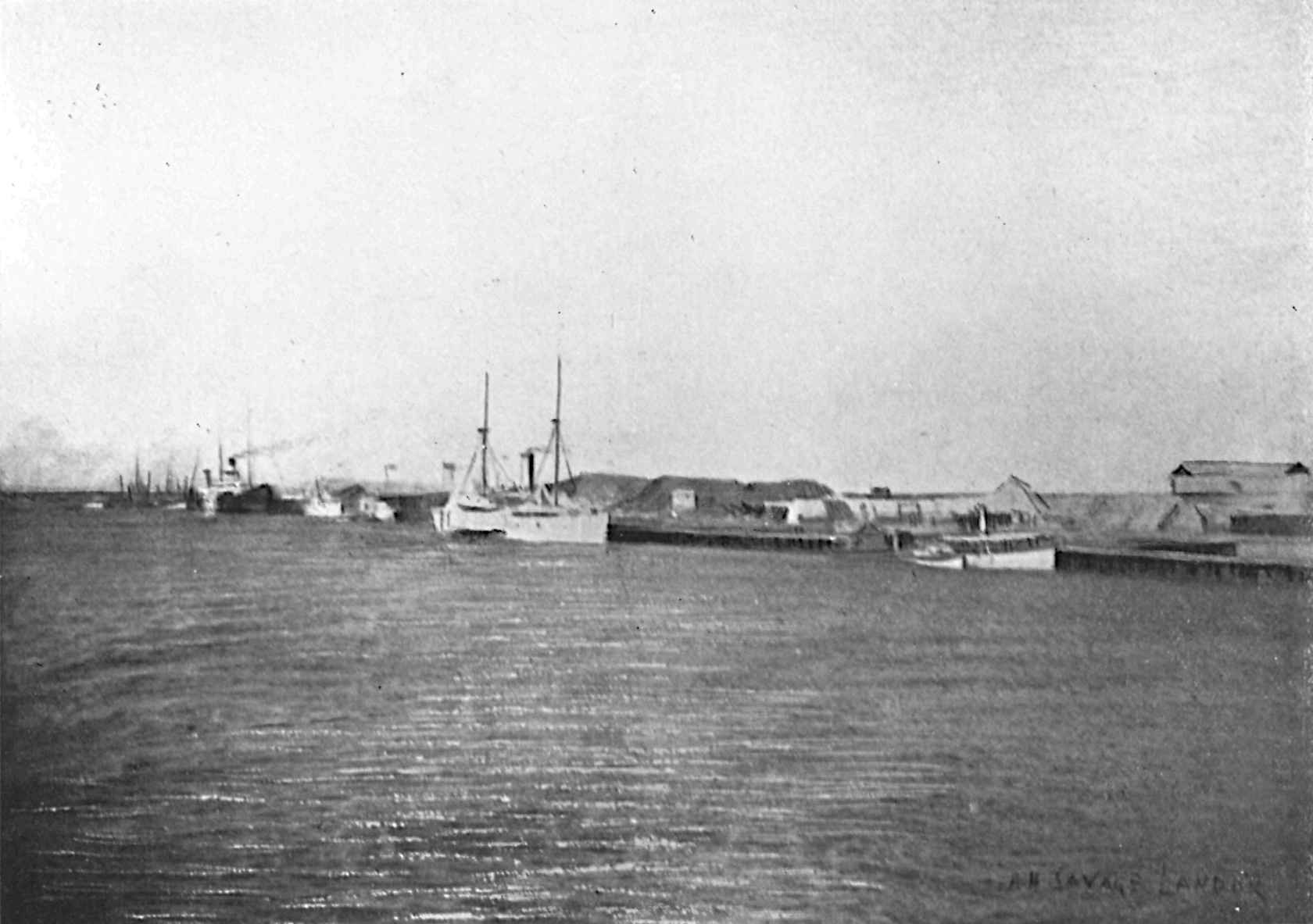 Boat next to harbor, across the water