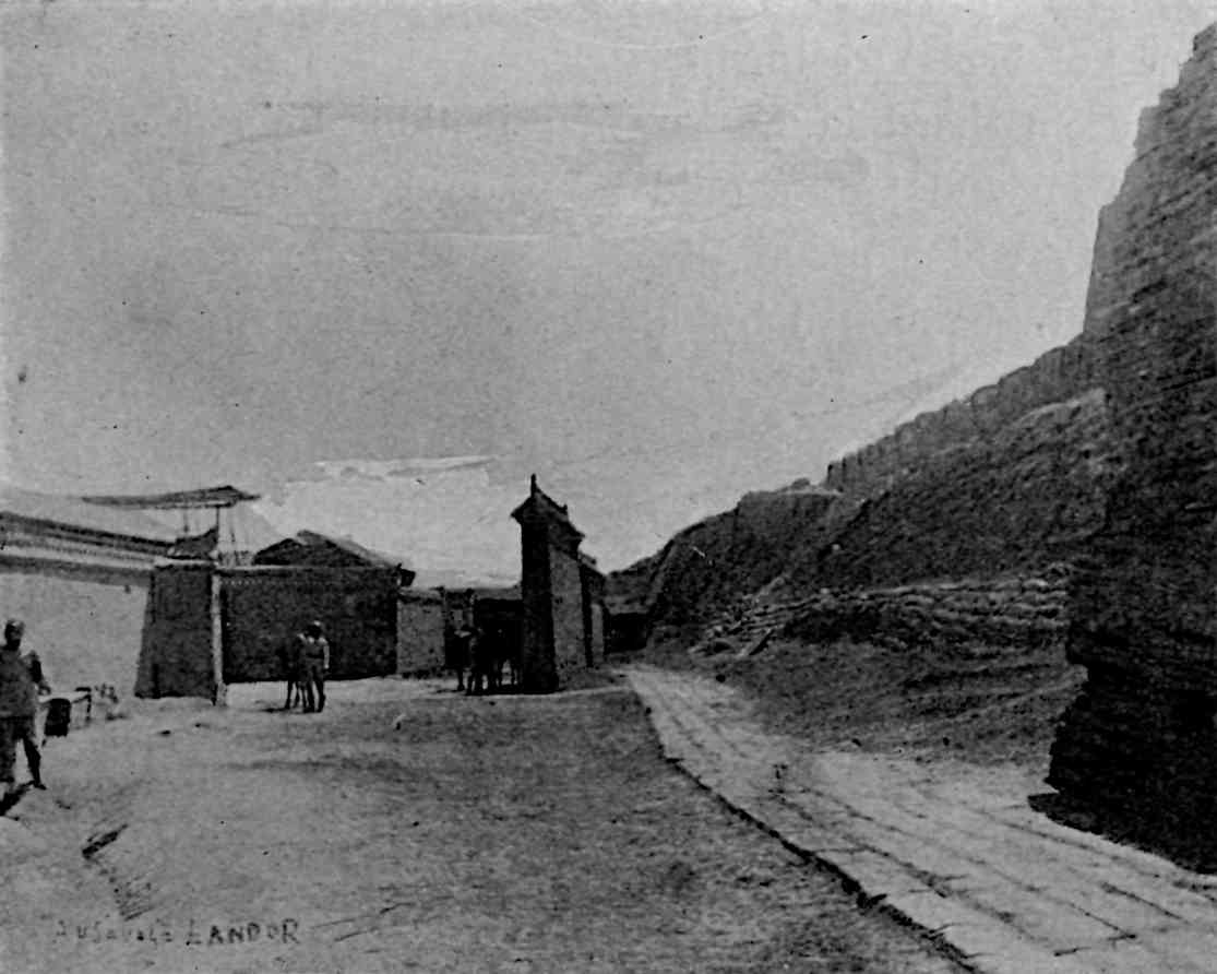 Walls to right and buildings to left