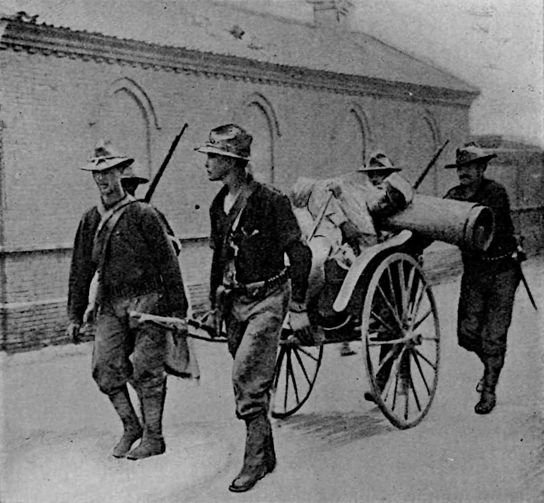 Men pulling and accompanying rickshaw with person on it