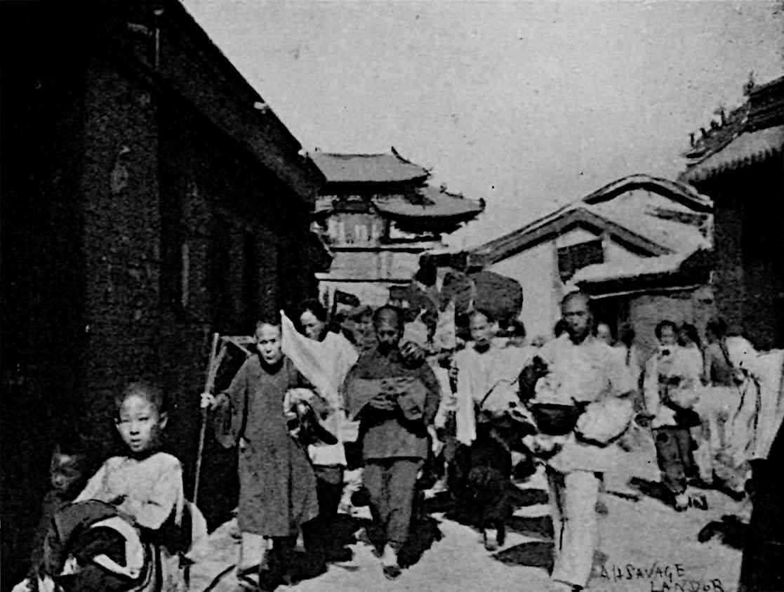 Many people walking, carrying items in front of buildings