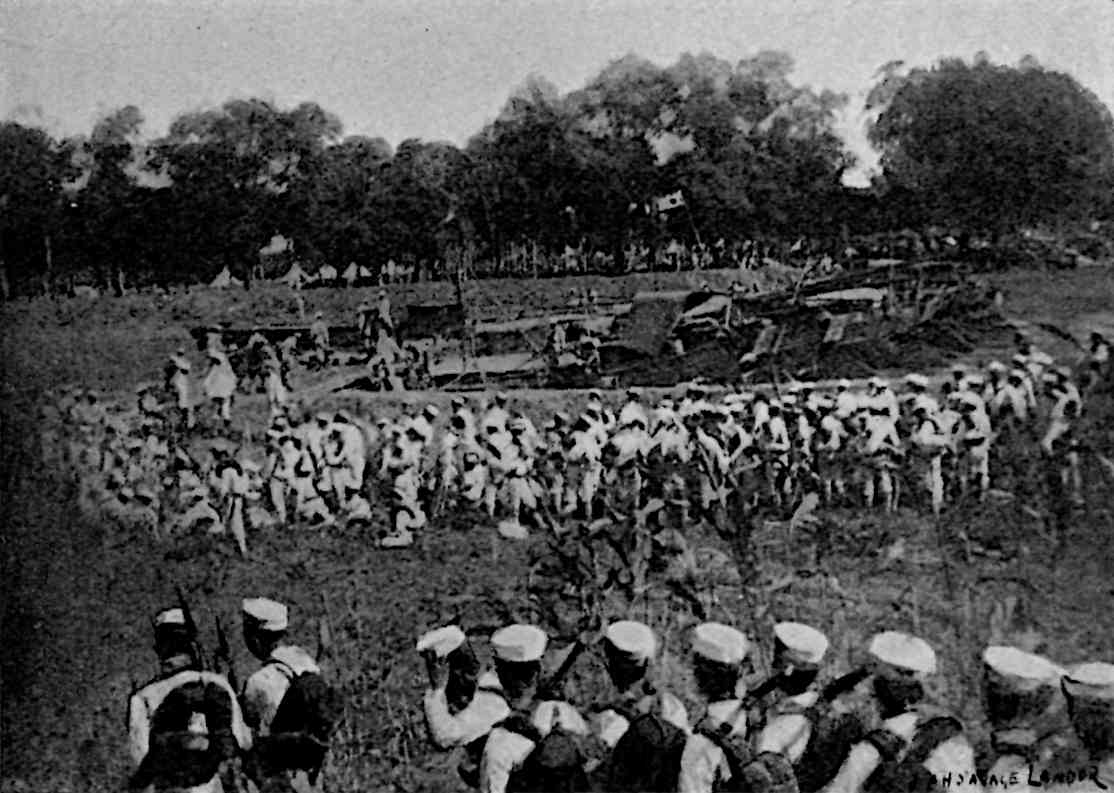 Many lines of groups of soldiers, with Japanese flag in background