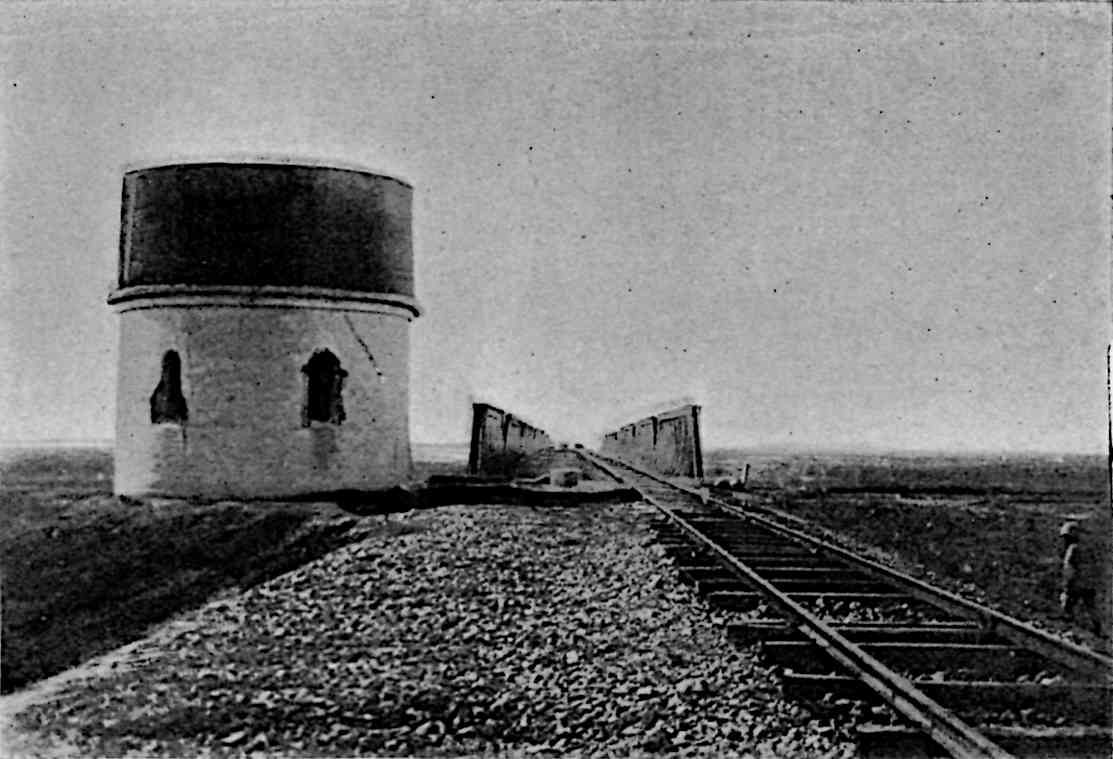 A railway next to a circular fortification, similar to a pillbox