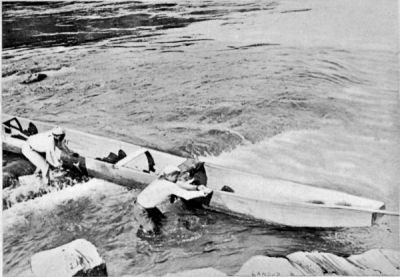 Conveying the Canoe by Hand down a Rapid.
