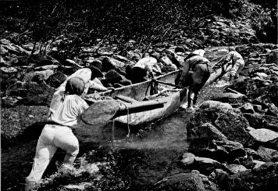 The Huge Canoe being taken through a Small Artificial Canal made in the Rocks by the Author and his Men.