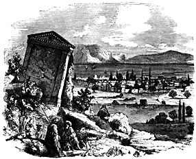 A city lies in the distance, surrounded by mountains. In the foreground there are ruins.
