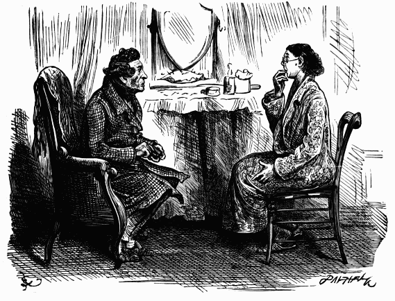 two people sitting down talking by a dressing table