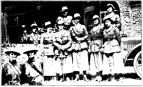 Then--the offered service of the Women's Reserve Ambulance Corps in England was spurned. Now--they wear shrapnel helmets while working during Zepplin raids