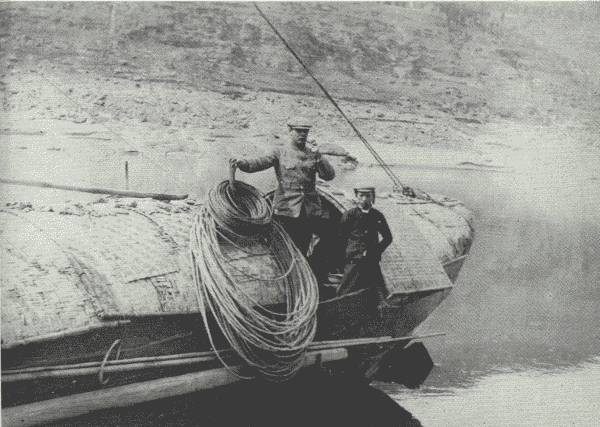 SCENE ON THE UPPER YANGTZE

Author and the cook on the aft of the houseboat after all the dangerous
rapids had been passed. The ropes are made of bamboo. En route to
Chung-king.