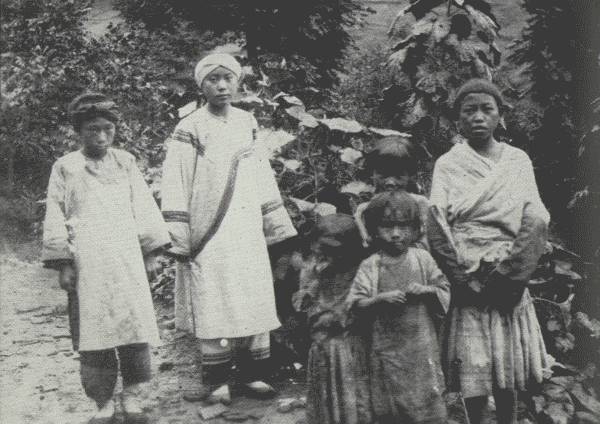 RATHER A RARE PICTURE OF TRIBES

Three tribes are shown: White Bones (left), attending her mistress, a
Nou-su aristocrat (Black Bones); the children at the right are Hua Miao.
