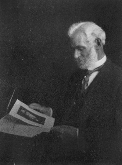 Author Francis F. Browne looking at papers