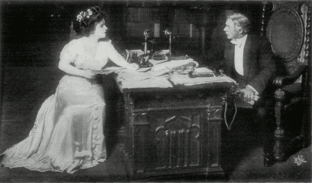[Photo, from the play,
of Shirley discussing her book with Mr. Ryder]