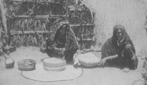 WOMEN GRINDING AT THE MILL.