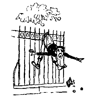 A man hangs from a fence by his trousers.