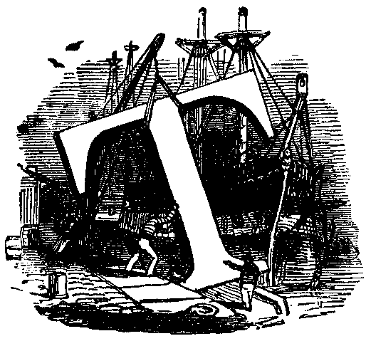 A letter T is hoisted in a shipyard.