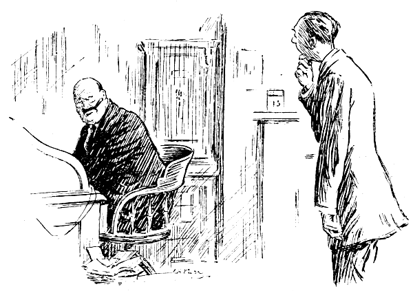 Clerk talking to man seated at desk.