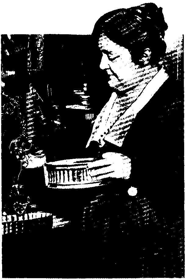 MRS. M.A. WILSON IN HER OWN WELL-EQUIPPED KITCHEN
