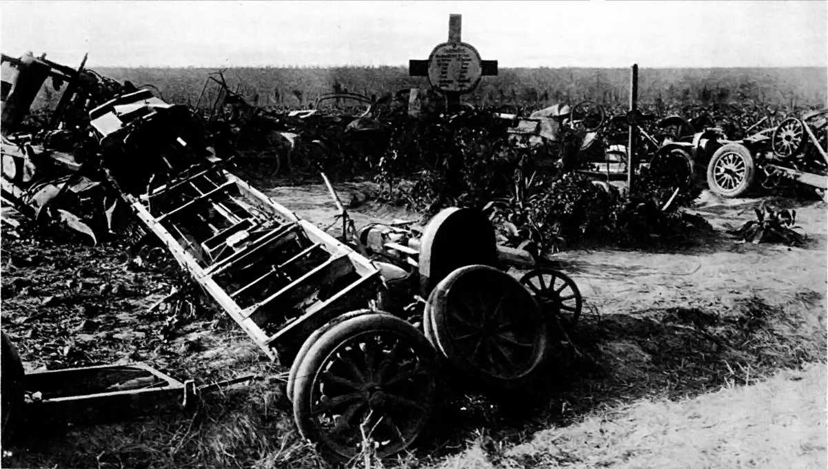 A HOLLOW SQUARE OF WRECKAGE: THE REMAINS OF A GERMAN MOTOR-TRANSPORT CONVOY GROUPED ROUND THE SOLDIERS' GRAVE.