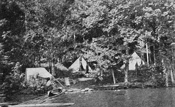 A forest camp by the water.