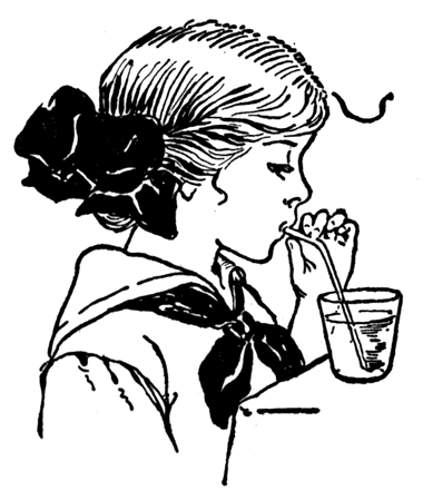 A girl blows through a straw into a glass of water.