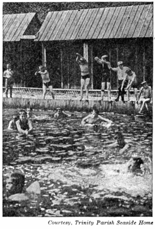 Boys playing in a swimming pool.