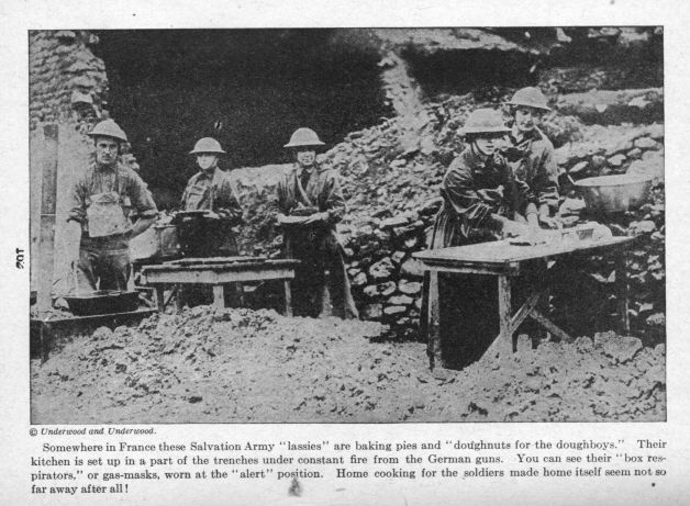 Somewhere in France these Salvation Army "lassies" are baking pies and "doughnuts for the doughboys."  Their kitchen is set up in a part of the trenches under constant fire from the German guns. You can see their "box respirators," or gas-masks, worn at the "alert" position.  Home cooking for the soldiers made home itself seem not so far away after all!