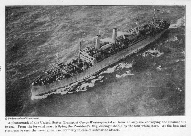 A photograph of the United States Transport George Washington taken from an airplane convoying the steamer out to sea. From the forward mast is flying the President's flag, distinguishable by the four white stars.  At the bow and stern can be seen the naval guns, used formerly in case of submarine attack.