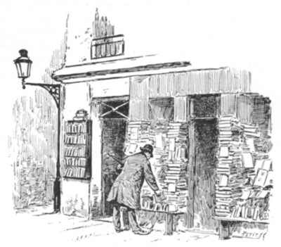 man examining books among tall jumbled piles in front of a bookshop