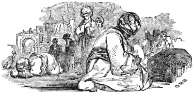 Men wearing robes and turbans sit, stand and kneel at prayer in a courtyard