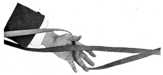 View from below of open hand with reins crossed under the palm