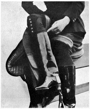 Woman seated in side-saddle on stand