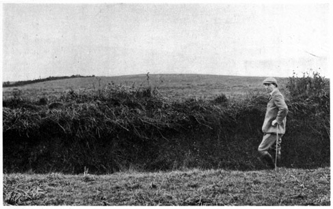 Man standing next to ditch of a Galway bank.