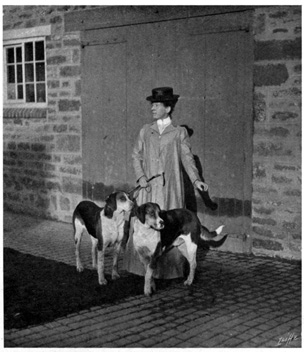 Woman standing with two hounds