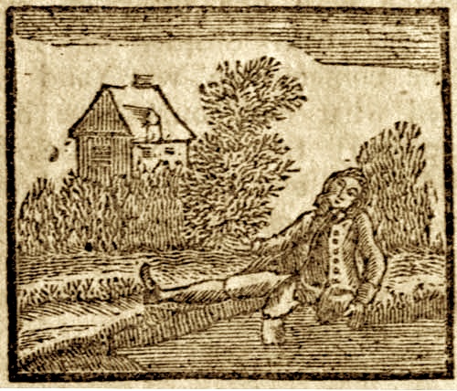 A man sitting on the ground in front of a house
