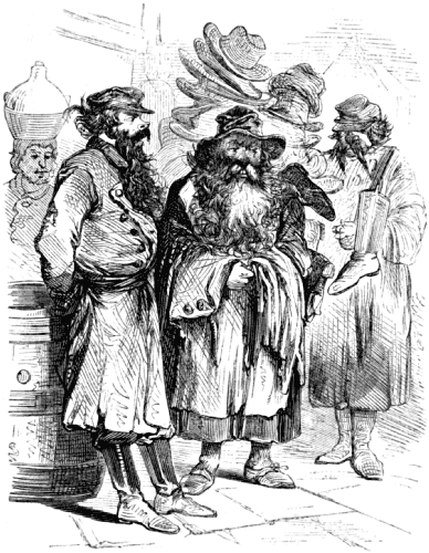 Three men stand by a stall piled high with hats