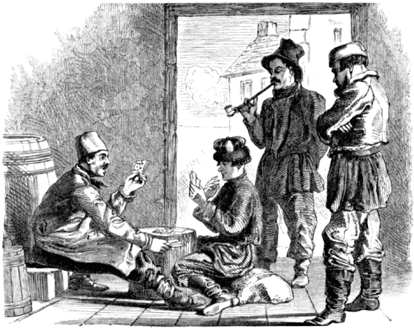 Two men look on as two others play a card game