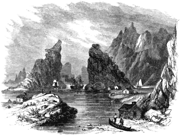 Towering rocks and cliffs, a few boats, and some small houses